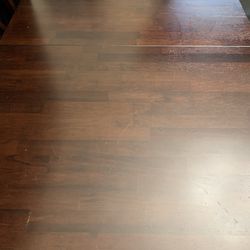 Expandable dining table with six chairs.