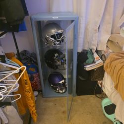 display case with professional helmets