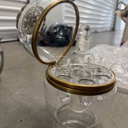 This is a vintage glass cordial set with a spherical case.