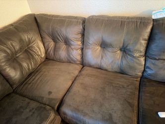 Grey L-shape couches with ottoman