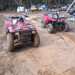 Polaris is an 88 the Arctic cat is 98 and I have a another Polaris I'm not sure of the year but it's the 2000 something The Polaris in the last pictures is all apart it's just the frame is good I have the motor all the four wheel drive is there I don't have all the parts to the engine I bought it like that The red Polaris and the red Arctic cat both need carburetor adjustments they have new carburetors on them the red Polaris two-cycle engine and has brand new tires in the back the front you're probably going to need some Arctic cat four cycle engine probably going to need tires you probably have a little while but they're kind of dry water