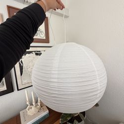 Hanging paper lantern with cord and light bulb