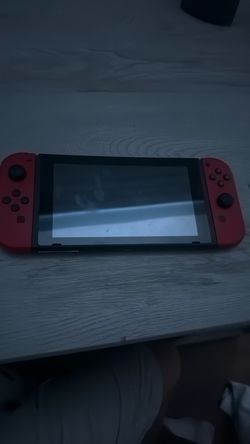 Nintendo Switch with Red Joy-Con Controllers