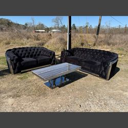 Acme Furniture Pyroden sofa and loveseat set in black velvet with a chrome finish with center table