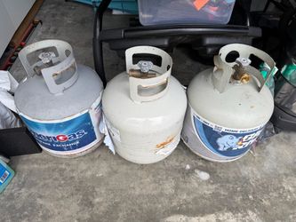 3 empty grill gas tanks