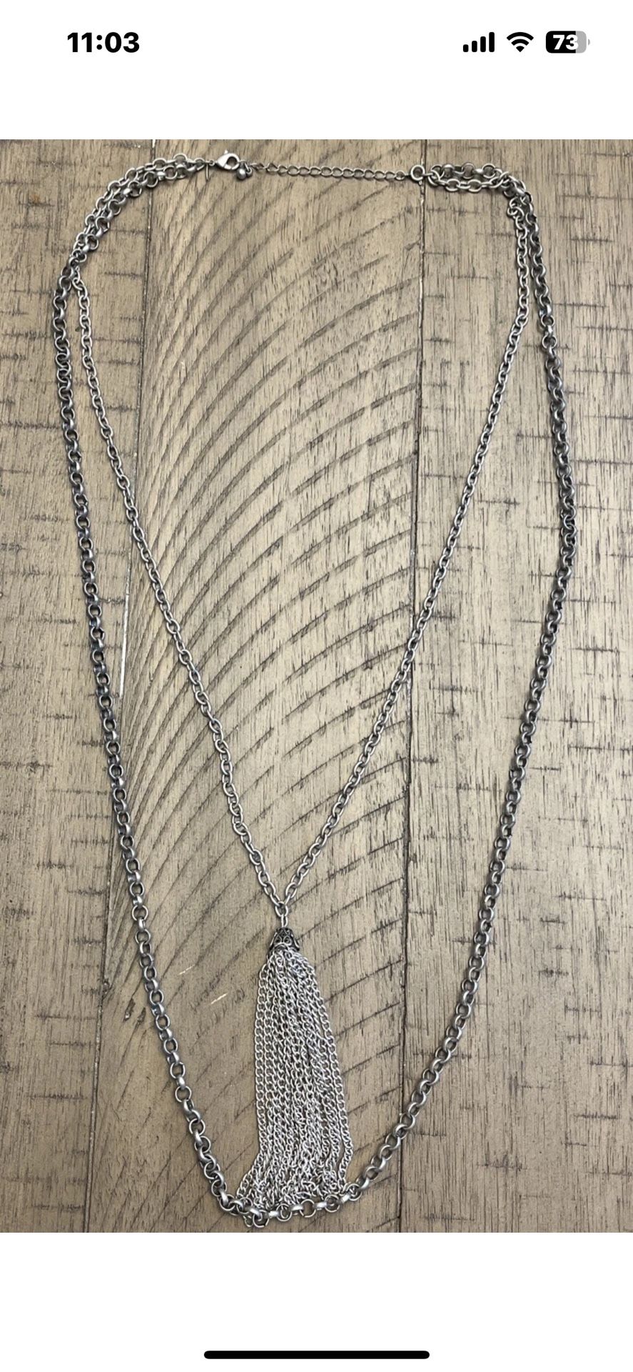 Two layered silver toned necklace with tassel charm