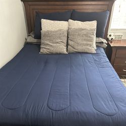 Bed with nightstand and dresser with mirror