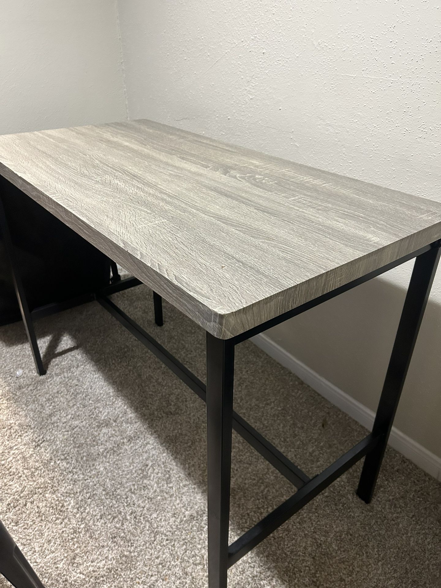 Small dining table with two black industrial stools 