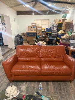 Live seat Couch for sale, orange leatherette.