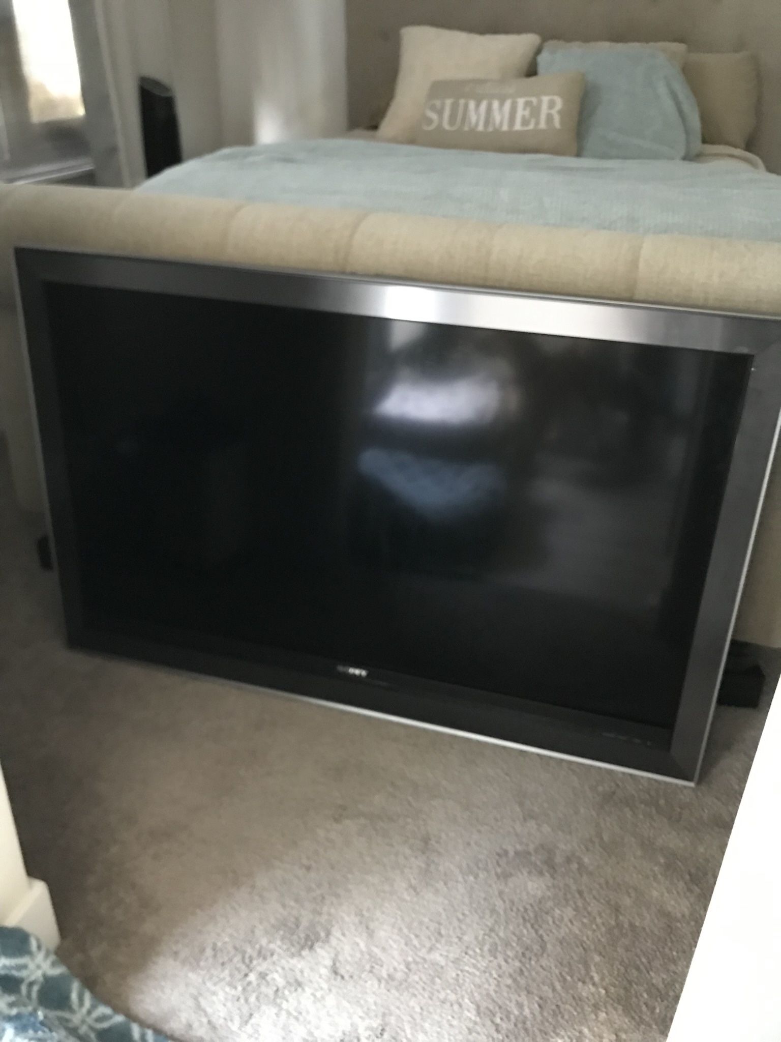 52 Inch Sony TV with cable cord and remote.