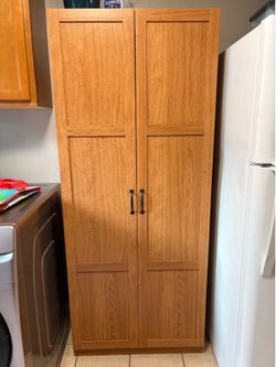 Oak Finish Two-Door Kitchen Pantry Cabinet