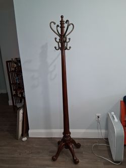 Standing Coat Rack. SIZE: 72" H x 19" W  Manufacturered by Powell.  Fluted posts taper to four hand forged Antique textured hooks.