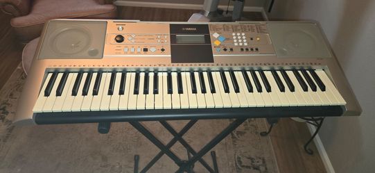 Yamaha YPT-320 is a 61-key, touch-sensitive portable electronic keyboard with stand