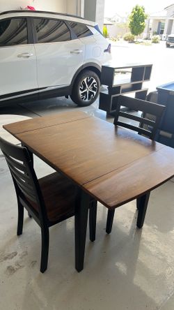 Brown table and two chairs