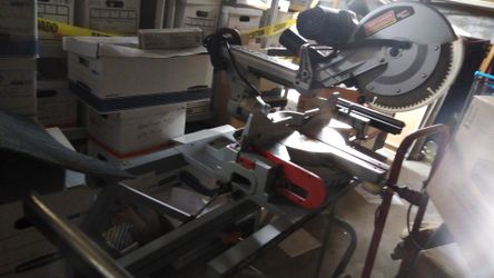 Craftsman compound miter saw mounted on a Ridgid table cart with roller extensions