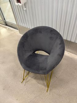 TOV Nolan rocking chair, upholstered in soft grey velvet with distinctive gold iron rocker. $150