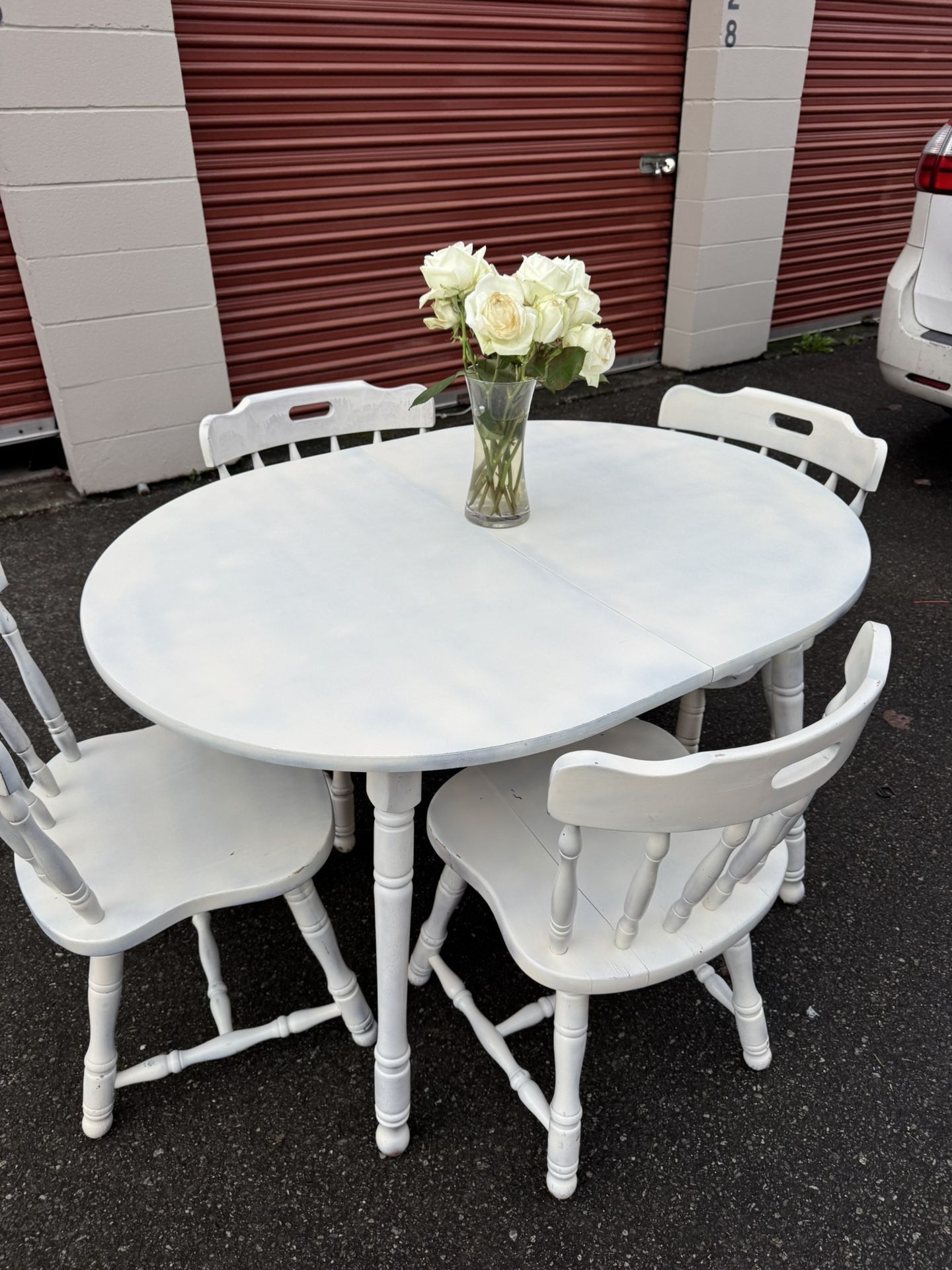 White wooden table and four chairs