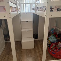 White wood twin loft bed with stairs, built-in closet, and storage