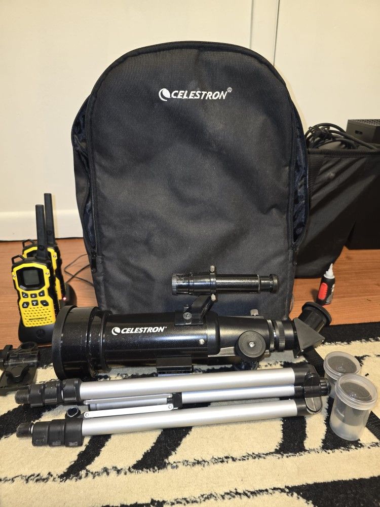 Celestron D70 telescope with a pair of walkie talkies and travel bag