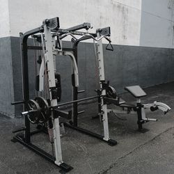 Gold's Gym Smith Machine Home Gym System with Bench and Weights. Zip33130. Delivery for extra
