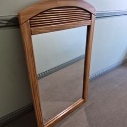 An arched wooden wall mirror Hobby Lobby