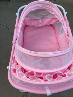 Pink baby bassinet