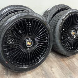 NEW 24 inch gloss black wheels with floating Cadillac caps wrapped in atturo az810 tires 285/40r24