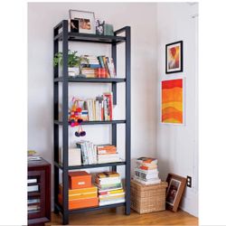 Crate & Barrel bookshelf includes sculptures on the shelves in the image and the desk