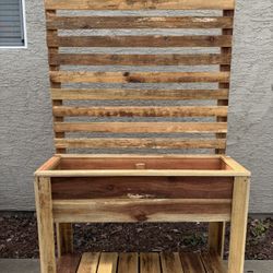 Redwood raised garden bed planter with a 6’ privacy fence and shelf.