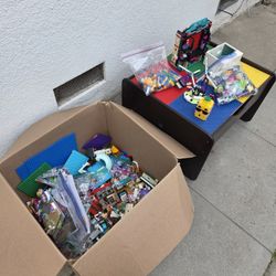 KidKraft Double-Sided Play Board Storage Table with a box of many Legos 