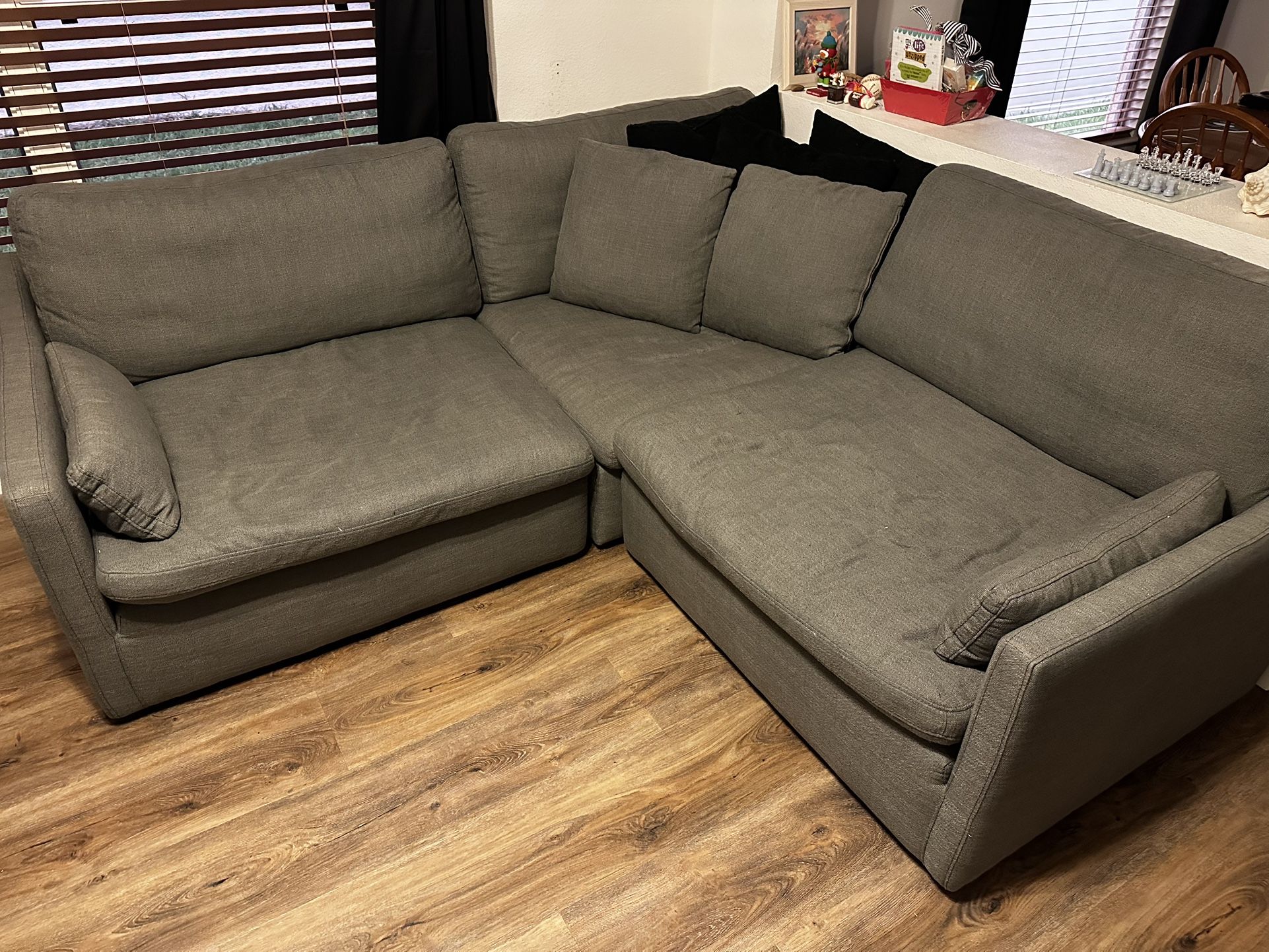 Three piece sectional couch with five pillows