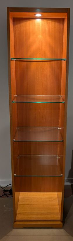 Wooden display cabinet with glass shelves and built-in lighting.