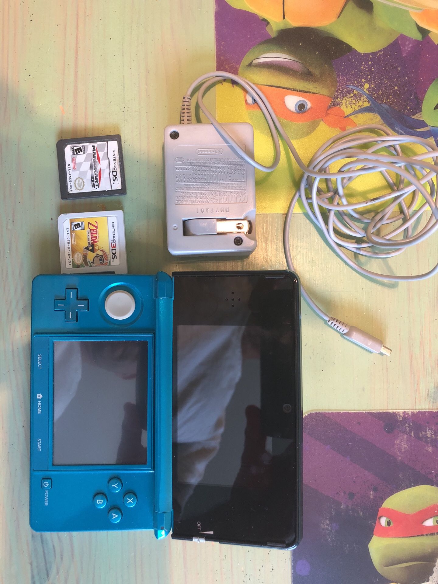 Nintendo 3DS plus charger and 2 games.