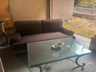 Brown fabric sofa and glass table