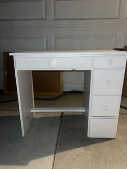white desk features four drawers central writing surface vanity