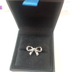 NEVER USED, SOLID 925 STERLING SILVER BOW RING WITH A REAL SMALL DIAMOND IN THE CENTER, SIZE 6 WITH ORIGINAL BOX , $115 OBO