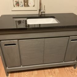 wooden cabinet with Stone vessel sink with Stein Still faucet
