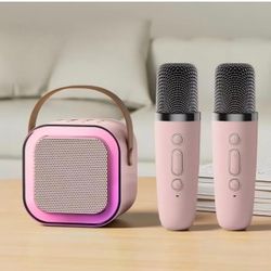Portable Karaoke Speaker with Two Wireless Microphones and RGB Lighting 1 speaker, 2 microphones; Bluetooth connectivity; pink color; compact design f