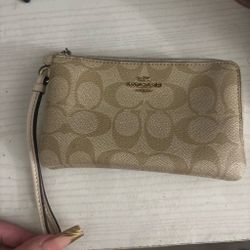 Beige and white coach wristlet