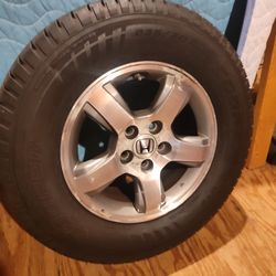 Honda 5 lug aluminum rim with a Cooper Evolution HT2 tire
