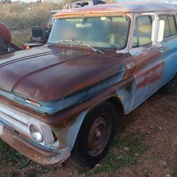1965 Chevrolet Suburban (C10/C20) — the body style and the “10” badge on the fender confirm it’s a C10 half-ton Suburban