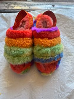 UGG Plush faux-shearling slides in bold rainbow stripes.