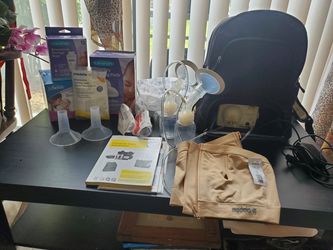 Medela breast pump, diapers, breast pads, storage containers