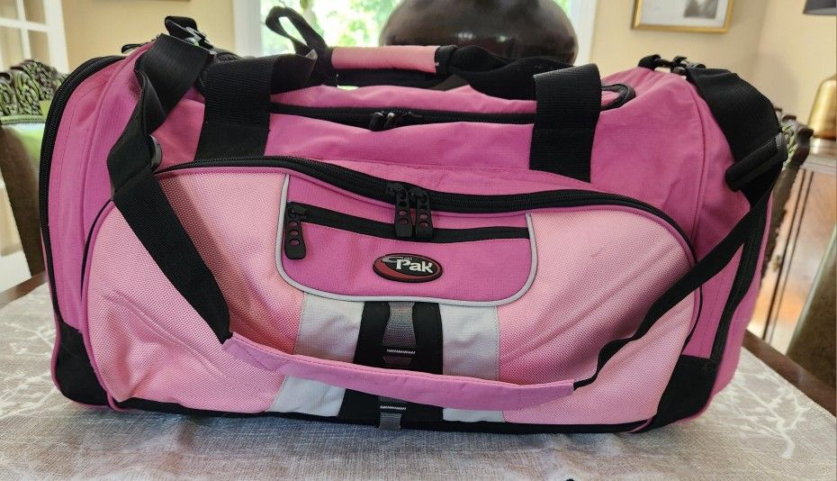 Large Travel Canvas Bag in Pink and Black. Two large side Outer Pockets with double zippers and carrying handles. Large storage compartment on top