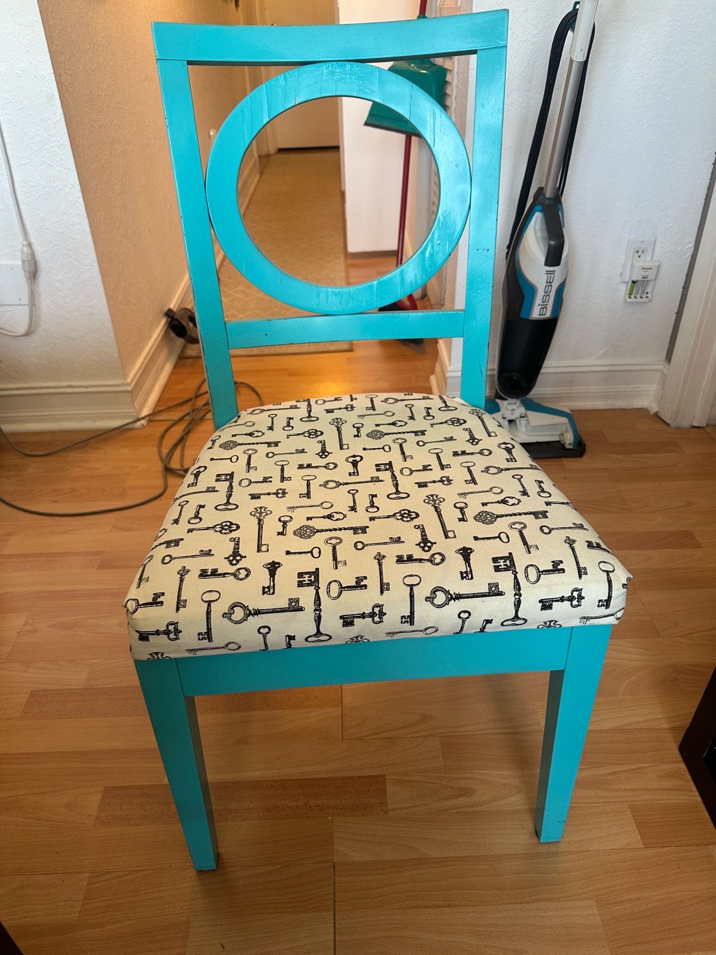 Blue wooden chair with upholstered cushion