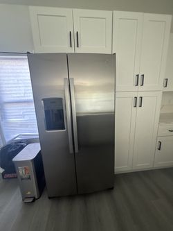 Stainless steel double door fridge. Half fridge half freezer.