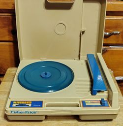 Vintage Fisher Price record player with story books and vinyls