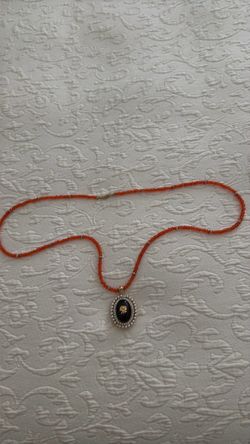 Women’s necklace with pendant that opens and holds photo.