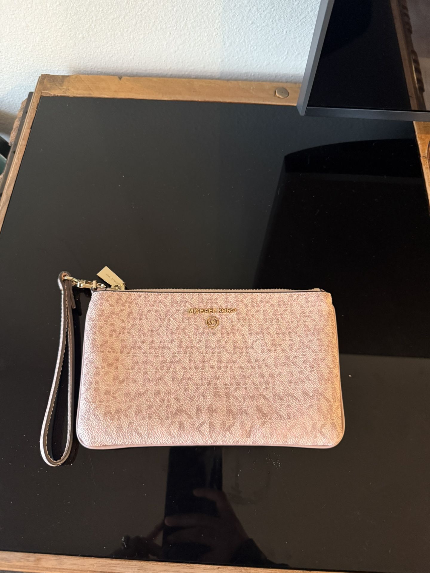 Michael Kors wristlet in blush pink MK monogram print.
