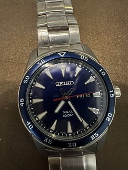Men’s Seiko Watch Silver Metal Band with Blue Face White markings for numbers and a white hands Solar powered needs sunlight to keep time no battery r